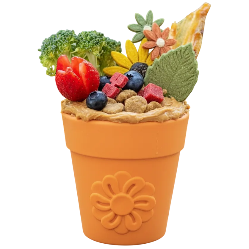 Flower Pot treat cup in orange on white, packed with peanut butter and kibble under berries, broccoli and treats