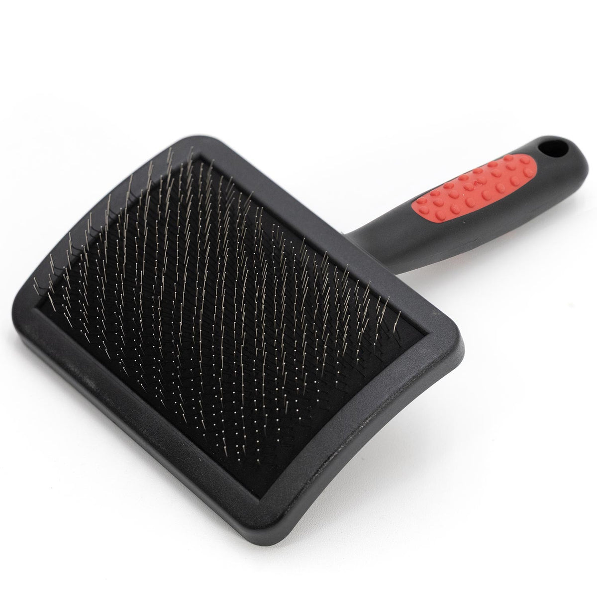 Jeffers slicker brush with a wide curved head and a black handle with a red dotted grip