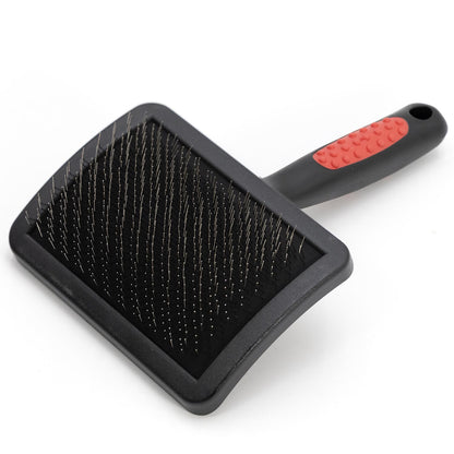 Jeffers slicker brush with a wide curved head and a black handle with a red dotted grip
