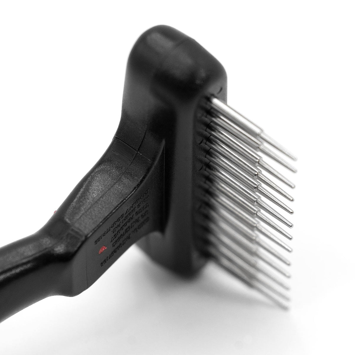 Side close-up of the Jeffers Magic Spring rake head showing its row of long rounded steel pins