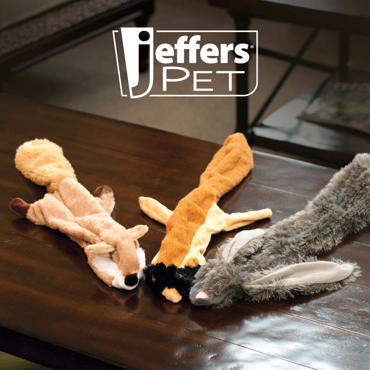 Jeffers Thinnies fox, chipmunk and rabbit plush dog toys lying on a wooden coffee table