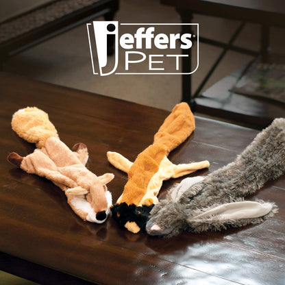Jeffers Thinnies fox, chipmunk and rabbit plush dog toys lying on a wooden coffee table