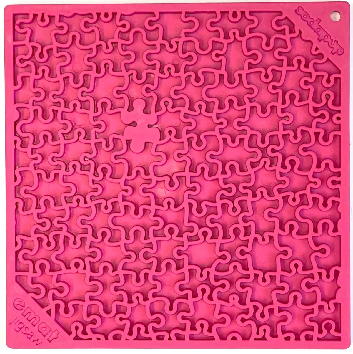Jigsaw eMat lick mat in pink, top view of the puzzle-piece pattern with the eMat jigsaw logo in one corner
