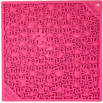 Jigsaw eMat lick mat in pink, top view of the puzzle-piece pattern with the eMat jigsaw logo in one corner