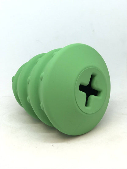 Christmas Tree treat dispenser tipped toward the camera, showing the cross-cut fill opening in its flat base