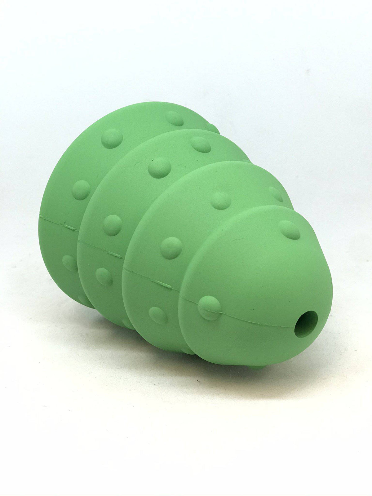 Christmas Tree treat dispenser lying on its side, showing the small air hole at the top of the tree