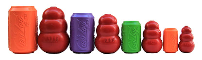 Four SodaPup Can Toys in orange, purple, green, and orange lined up beside similar red rubber toys for size comparison
